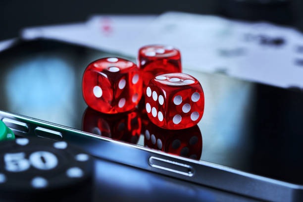 Baccarat table with dealer holding two hands of cards ready for reveal